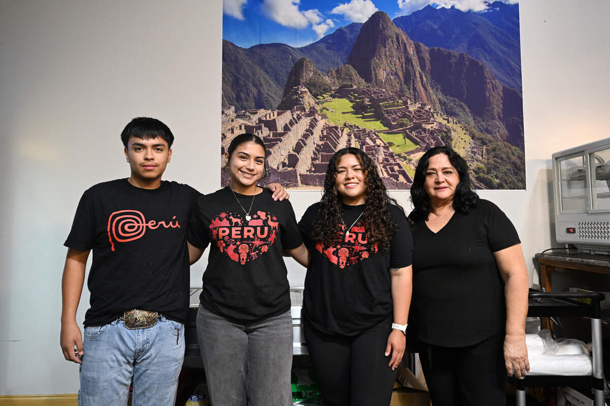 Co-owner Jessy Parades (second from right) poses with her aunt Gladys Cabrejo (right), her niece Alyssa Paredes (second from left) and family friend Walter Martinez behind the counter at Asu Mare Peruvian Restaurant in Centerville, Georgia.