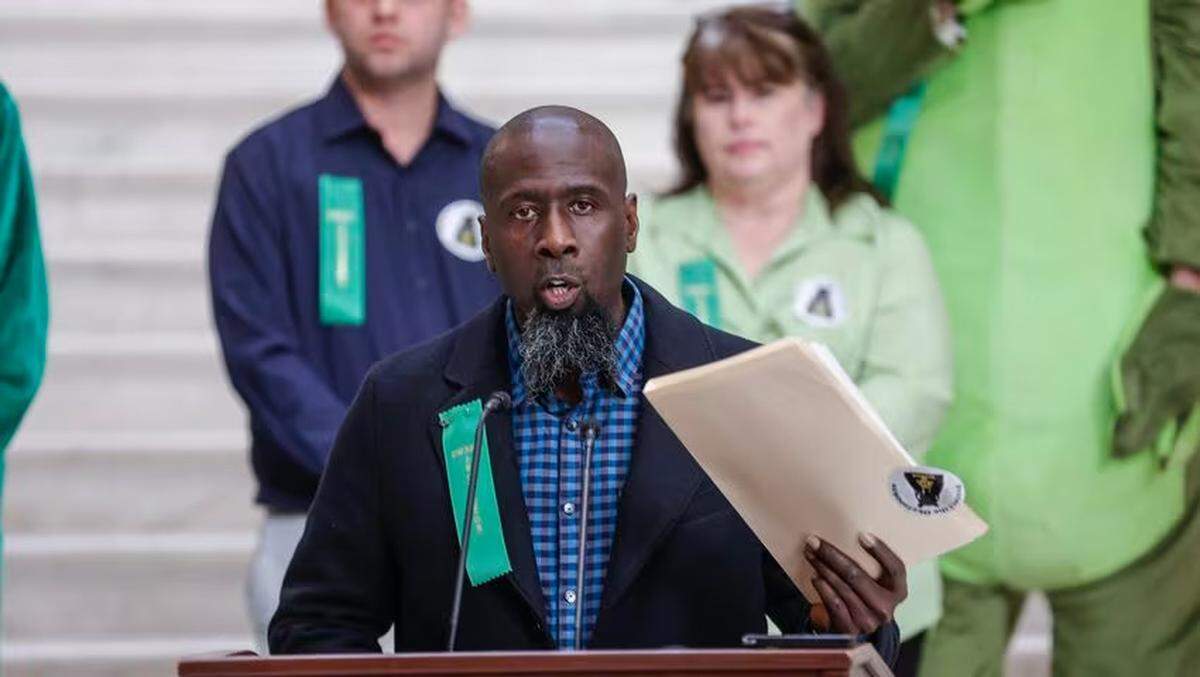 The Rev. Antwon Nixon holds a folder with signed petitions in support of House Bill 71 at the Georgia State Capitol on Monday, Jan. 29, 2024. The legislation, also known at the Okefenokee Protection Act, would protect the wildlife refuge from the construction of a titanium mine.