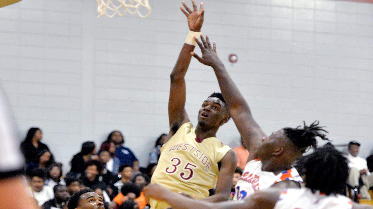 Westside's Khavon Moore (35) puts up a shot over Central's Kentrevious Jones (00) during their game Tuesday night.