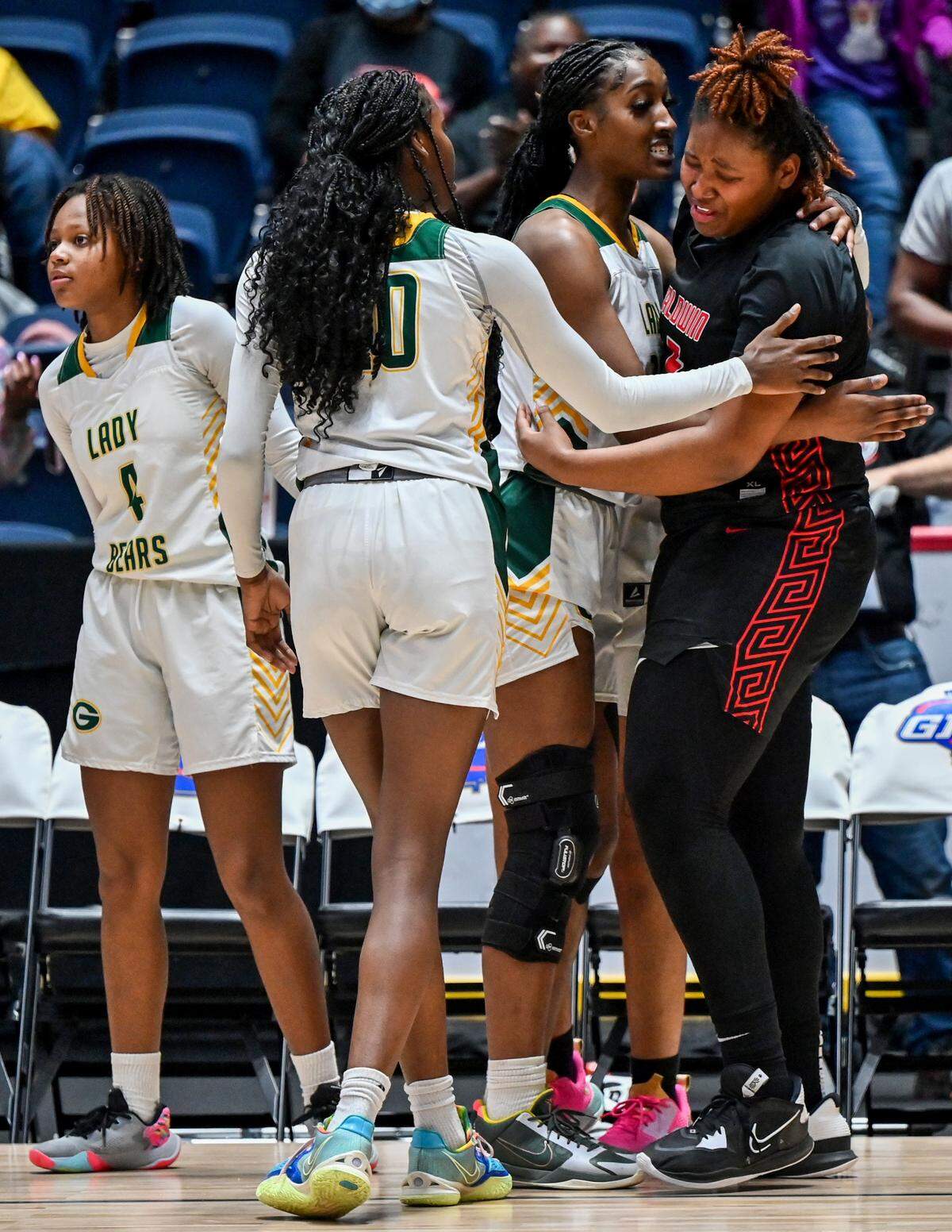 Baldwin’s Janaye Walker (5) is consoled by Griffin players after the Bralettes’ 51-47 loss to the Lady Bears in the GHSA 4A State Championship Wednesday in Macon.