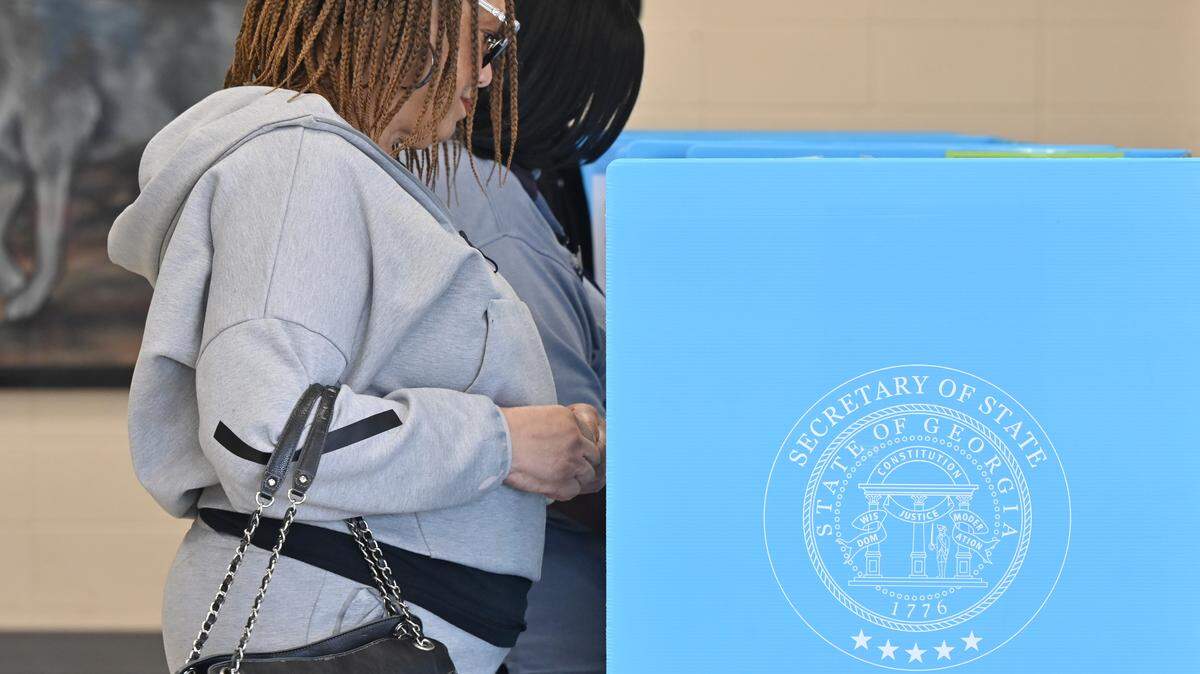 Marisa Mabry, from Warner Robins, casts her vote inside of Feagin Mills Middle School on Tuesday, Nov. 4, 2025, in Warner Robins, Georgia. The City of Warner Robins mayor is one of a handful of ballot initiatives this election cycle in Middle Georgia.