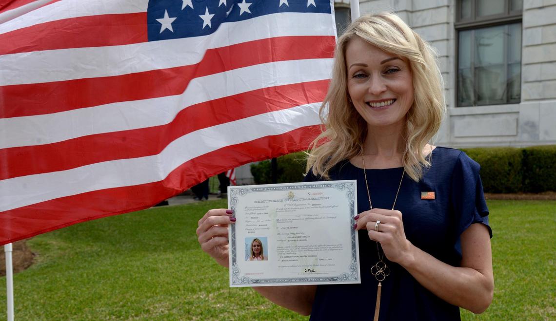 JENNA EASON/THE TELEGRAPH Macon, GA, 04/17/2019: Olga Collins holds up her Certificate of Naturalization for a photograph after her naturalization ceremony in the William Augustus Bootle Federal Building and U.S. Courthouse on Wednesday, April 17, 2019.