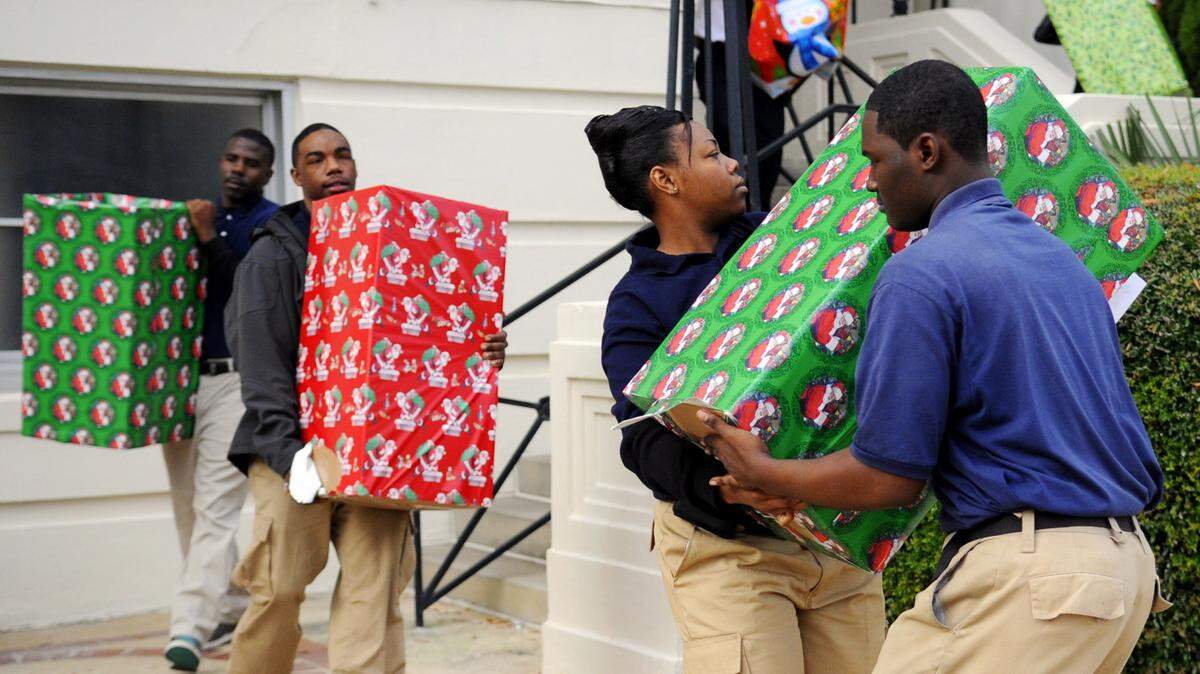 WOODY MARSHALL/THE TELEGRAPHBoxes of gifts are loaded into a waiting van for the 2011 Mayor's Christmas Motorcade to Milledgeville.