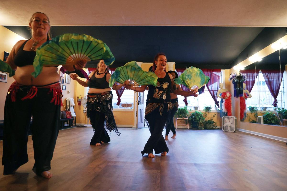 Dancers in the advanced belly dancing class warm up with a fan dance at Perry Belly Dance Studio on Thursday, Aug. 29, 2024, in Perry, Georgia. Perry Belly Dance Studio opened in 2010 and offers classes for all ages and skill levels.