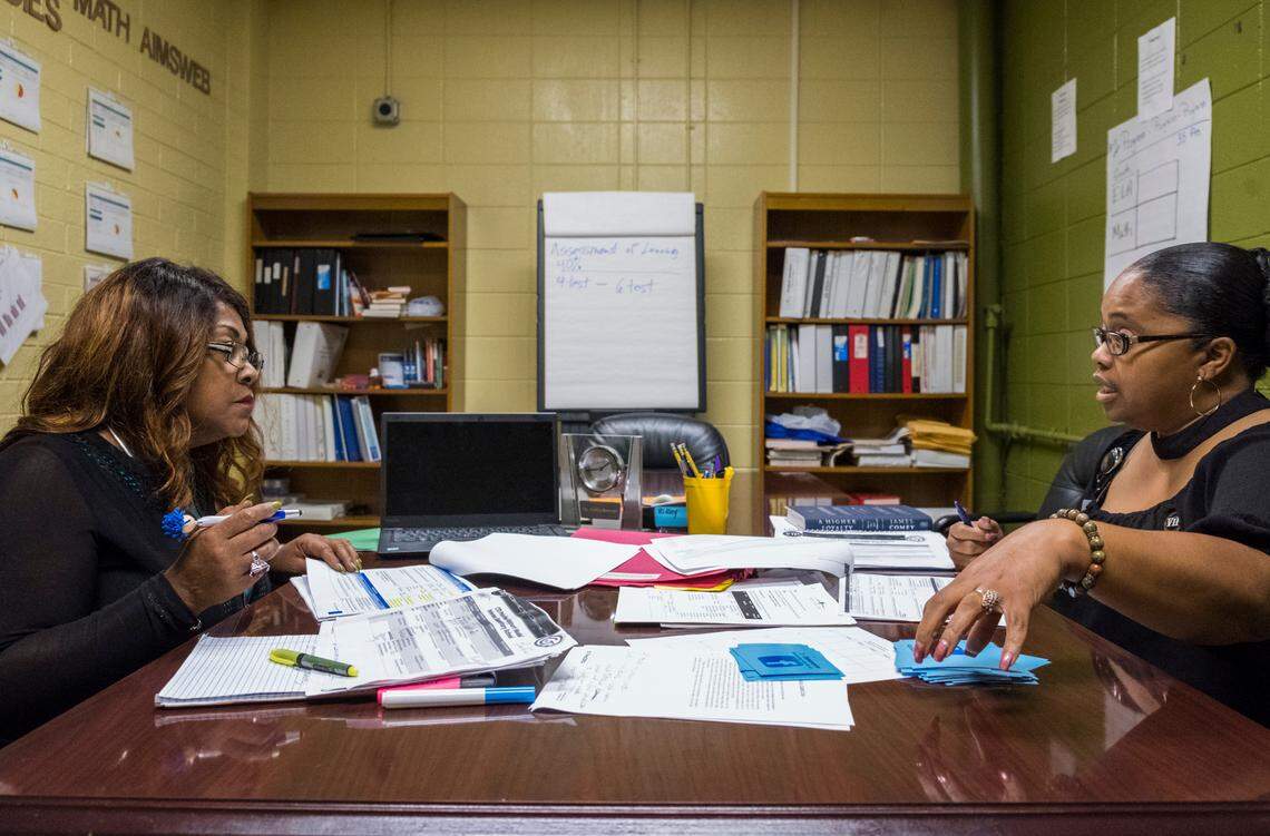 Betty Jones of the Chief Turnaround Office, left, and Principal Shandrina Griffin-Stewart go their shared plan for progress at Appling Middle School in Macon.