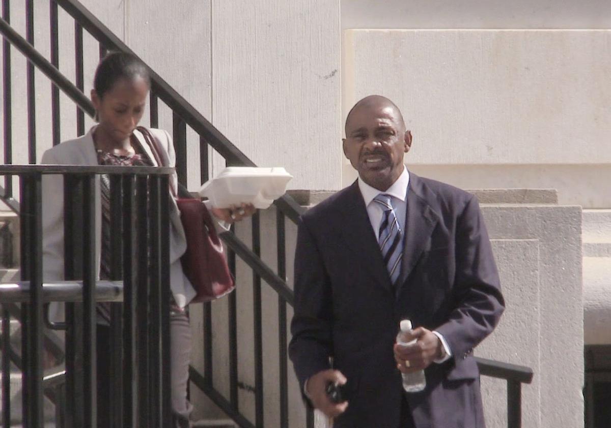Cliffard Whitby, right, makes his way from the U.S. District Court Monday after a full day of cross examination of former Bibb schools Superintendent Romain Dallemand. Whitby and Tallahassee attorney Harold Knowles are being tried on bribery and money laundering charges.