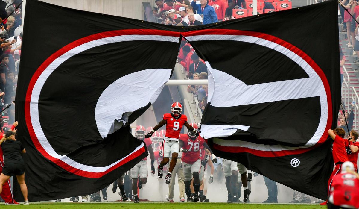 Georgia wide receiver Jackson Meeks (9) busts through the banner prior to the Bulldogs’ game against Samford Saturday in Athens.