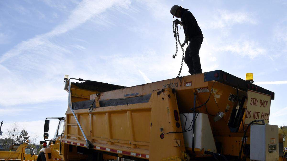 Brandon Carmichael, a Georgia Department of Transportation maintenance crew member in Macon, prepares a salt truck Tuesday in advance of the threat of possible snow flurries across the midstate.