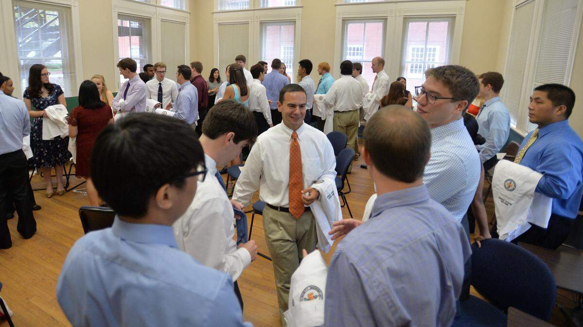Brian Wright, center, and more than 60 other new Mercer University medical school students prepare to be welcomed into the profession Saturday afternoon during ceremonies at Willingham Hall.