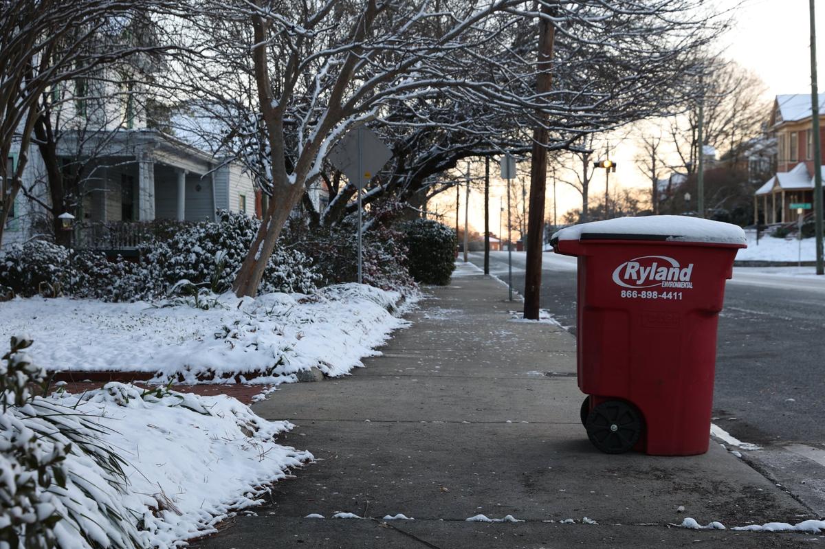 Snow sits on top of a garbage can off of College Street on the morning of Wednesday, Jan. 22, 2025, in Macon, Georgia. An estimated 2-3 inches of snow accumulated in most of Middle Georgia yesterday afternoon, with freezing temperatures and slippery roads remaining.