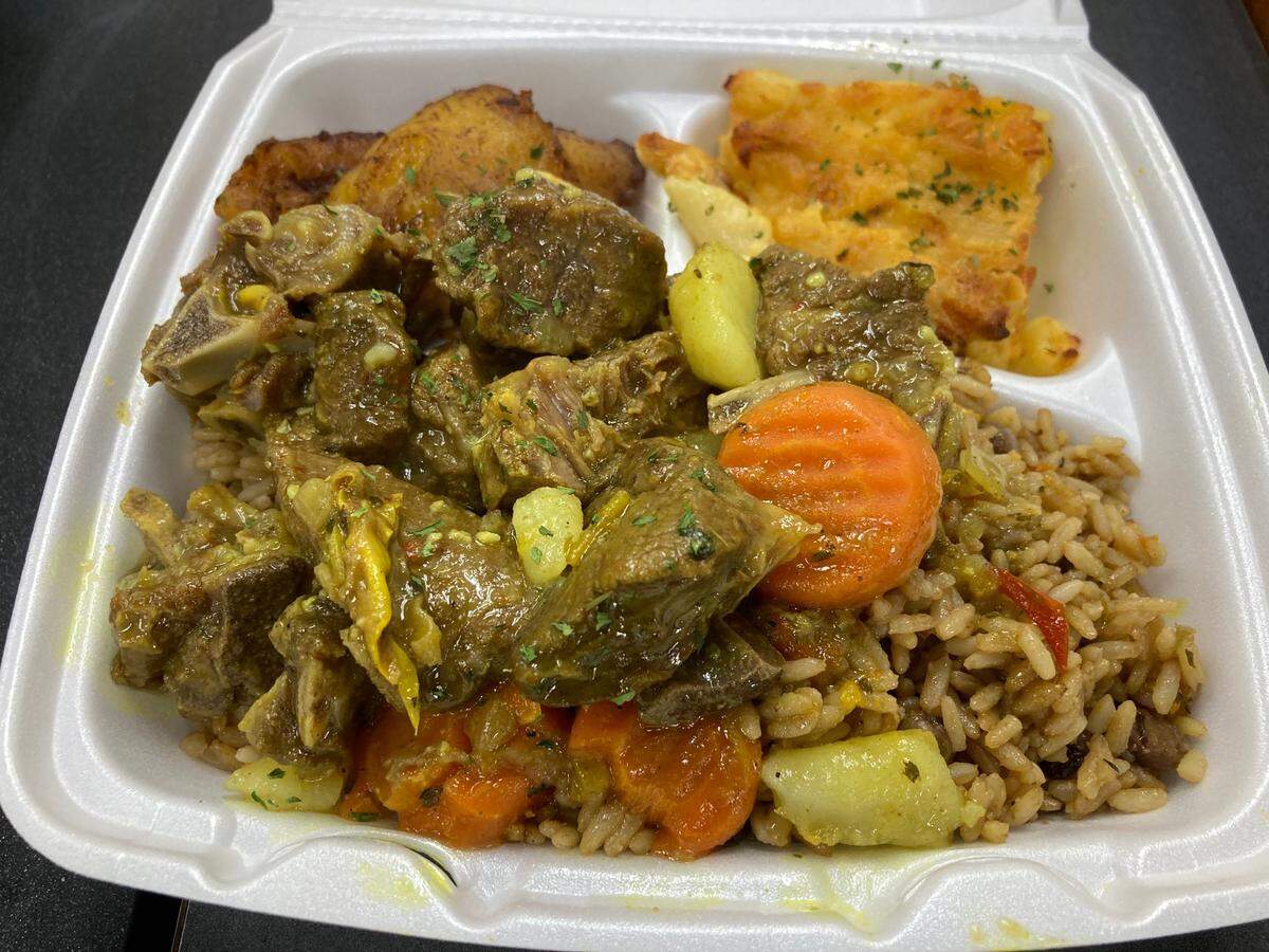 Curry goat with peas and rice, fried plantains and baked mac and cheese at Bahamas Caribbean Cuisine, a new restaurant in Warner Robins.