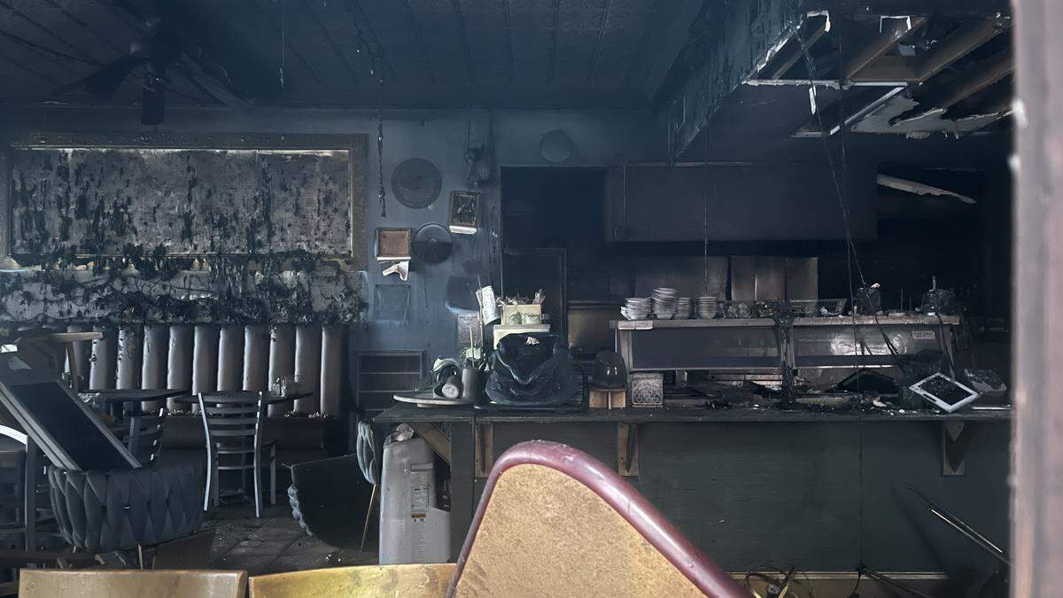 The inside of a 578 Southern Style Cuisine, a soul food restaurant in downtown Macon, Ga., was seen covered in soot through a window around 6:30 p.m. on Sept. 29, 2025, hours after it was destroyed by a structure fire, according to the Macon-Bibb Fire Department.
