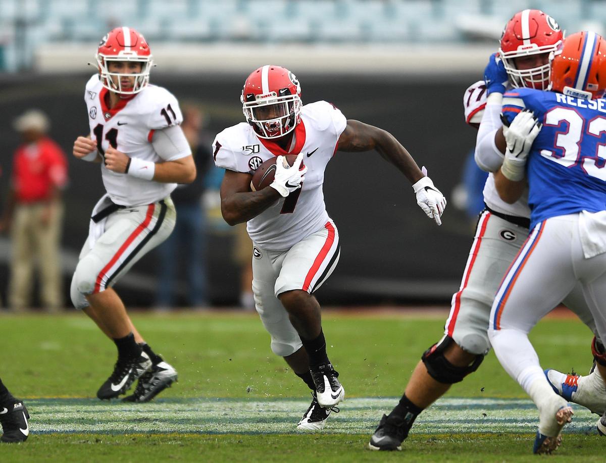 Georgia running back D’Andre Swift finds a gap the Gator defense and heads for a first down Saturday in Jacksonville.