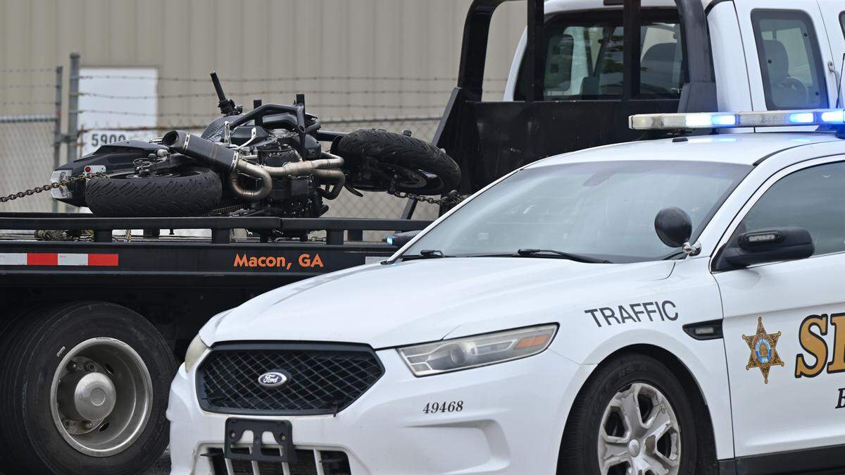 A damaged motorcycle sits on a tow truck off of Columbus Road on Thursday, Aug. 7, 2025, in Macon, Georgia. An accident involving a motorcycles and a minivan temporarily closed the road Thursday morning. 