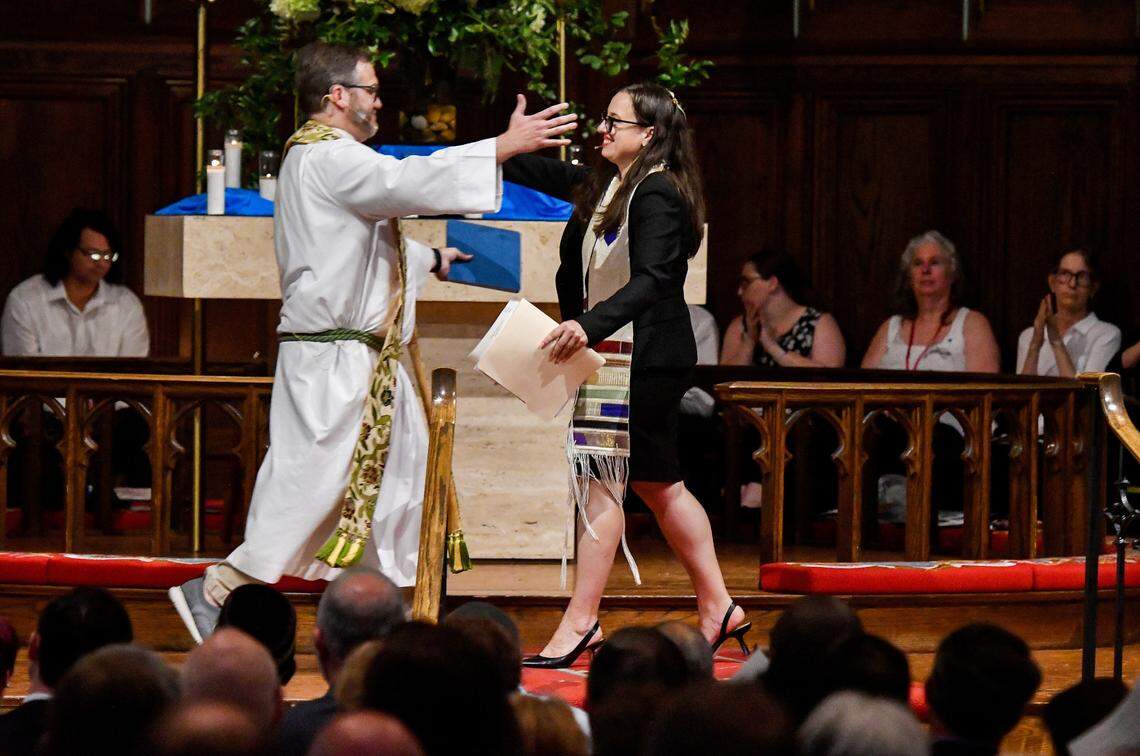 The Rev. Ted Goshorn with Mulberry Street United Methodist Church hugs Rabbi Elizabeth Bahar with Temple Beth Israel Sunday during “ A Service for Unity and Love” held at Mulberry Methodist. The event was put together after an antisemitic group gathered outside the Temple last week.