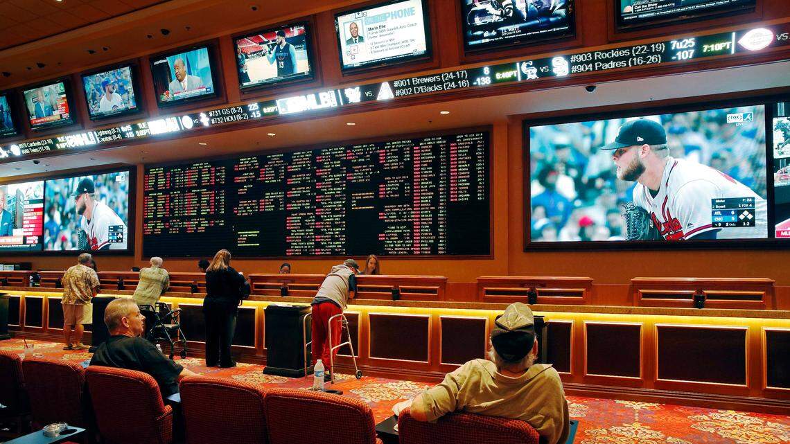 People make bets at the South Point hotel and casino sports book in Las Vegas, as an Atlanta Braves game plays.