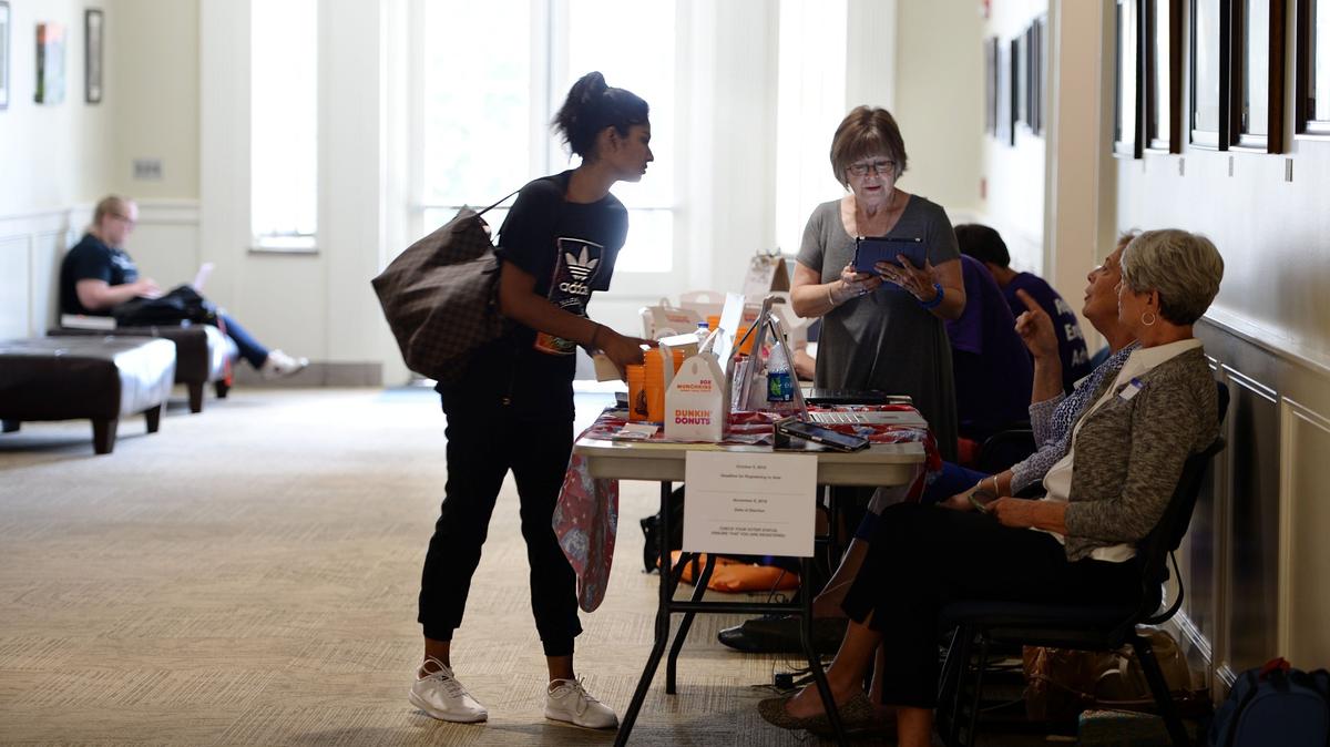 Esha Patel, center, gets help registering to vote from Gail Johnston at Mercer University’s Walter F. George School of Law in Georgia on Tuesday, National Voter Registration Day.