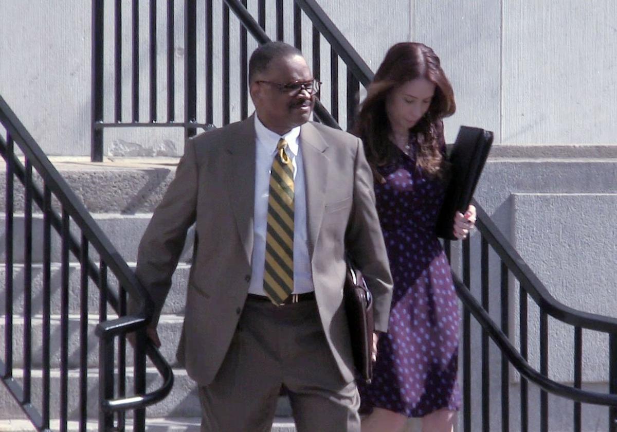 Tallahassee, Florida, attorney Harold Knowles, left, making his way out of U.S. District Court early in his trial on federal bribery and money laundering charges.