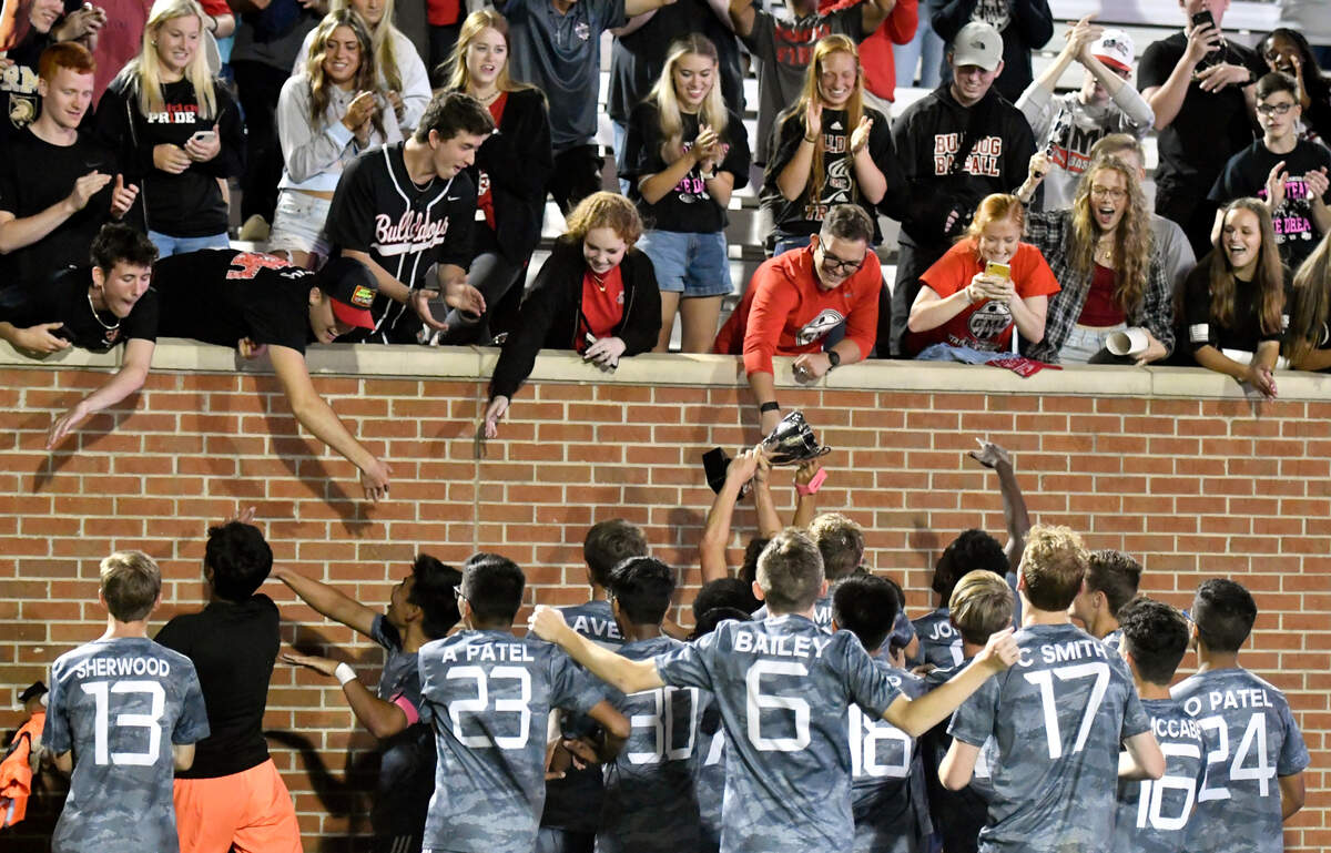 GMC players celebrate with fans after the BulldogsÕ GHSA 1A State Championship win over ACE Friday night at Mercer.