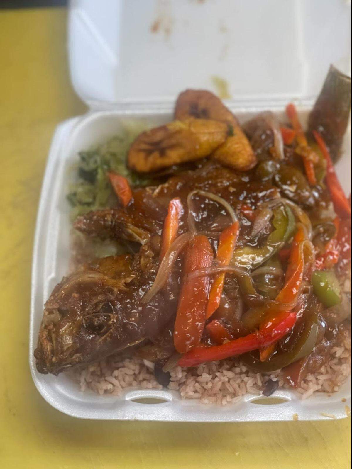 Brown stew red snapper with rice and peas at Crooklyn New York Caribbean Cuisine.