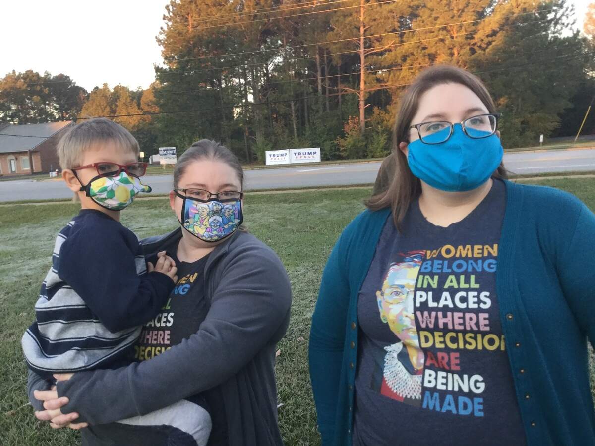 Sisters Megan Vaughn, 26, right, and her sister, Leisa Vaughn, 33, who’s holding their 5-year-old nephew, in line to vote early Tuesday morning. They dropped out of the line to vote at the Houston County Annex when a poll worker announced that the machines were down about 7:30 a.m.