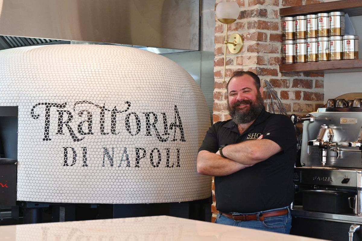 Trattoria di Napoli owner and operator John Staurulakis poses next to the restaurant’s custom brick pizza oven on Wednesday, Aug. 7, 2024, in downtown Perry, Georgia. Staurulakis has worked in the restaurant industry for most of his life, but soon will open Trattoria di Napoli as his first restaurant.