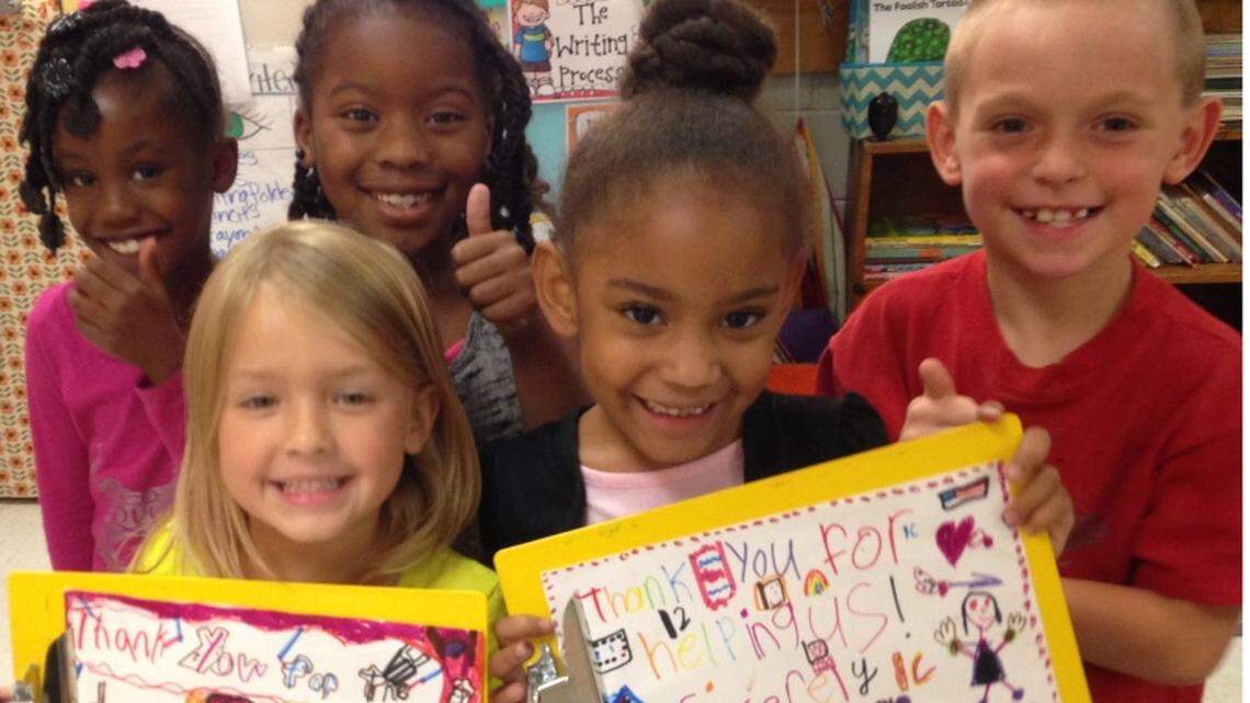 Students in Elizabeth Selman's first-grade class at Wells Elementary in Jones County in 2014 show off the clipboards they received through funding from DonorsChoose.org. Selman, who is now at Hubbard Elementary in Monroe County, submitted the proposal for the funding.