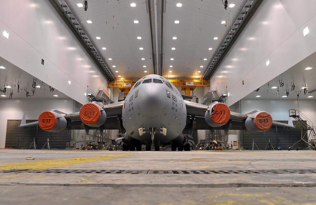 A freshly painted C-17 Globemaster rests inside a paint facility at the Warner Robins Air Logistics Complex. The surfaces of aircraft at the installation are completely stripped of paint early in the programmed depot maintenance process. Removing paint allows for thorough inspections at a later stage. (U.S. Air Force photo by Tommie Horton)