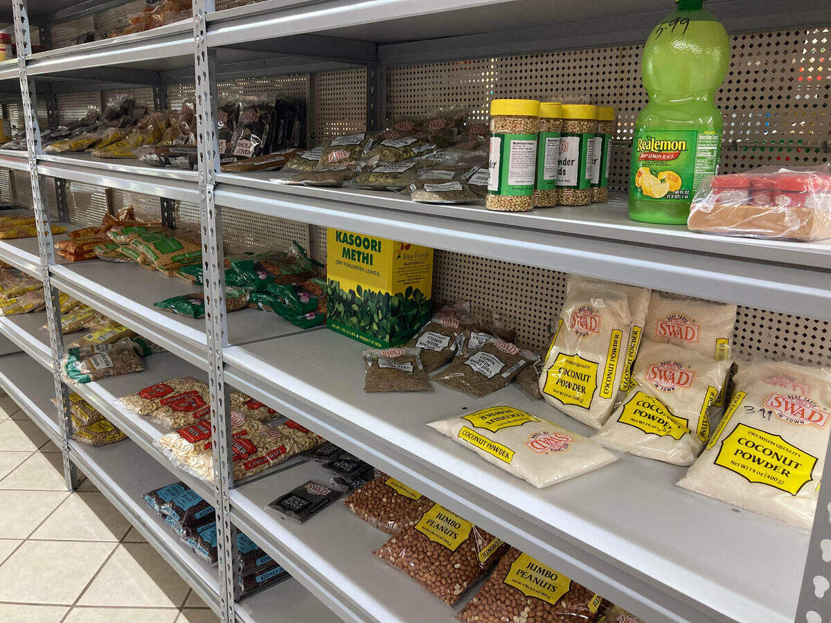 A long aisle of shelves filled mostly with spices, lentils, rice and teas at Alex Indian Food & Fast Food in Centerville near Warner Robins.