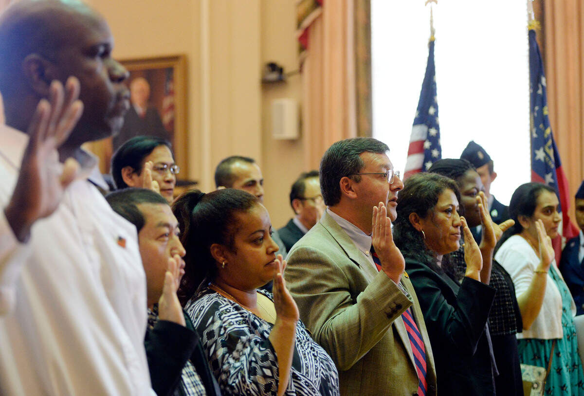 Twenty-two people raised their hands to make an Oath of Allegiance during a naturalization ceremony in the United States District Court for the Middle District of Georgia. Judge Marc Treadwell presided over the April 25 ceremony where people from 18 countries Pledged Allegiance to the American flag for the first time as U.S. citizens.