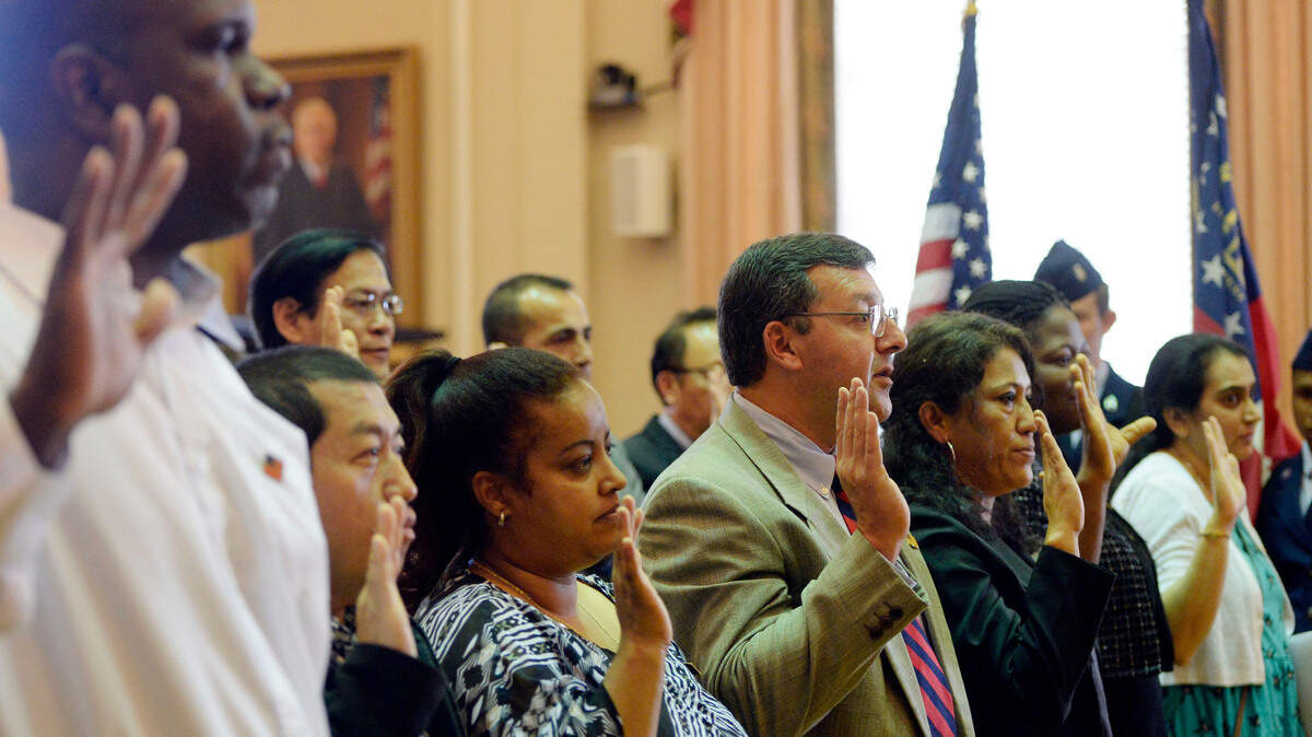 Twenty-two people raised their hands to make an Oath of Allegiance during a naturalization ceremony in the United States District Court for the Middle District of Georgia. Judge Marc Treadwell presided over the April 25 ceremony where people from 18 countries Pledged Allegiance to the American flag for the first time as U.S. citizens.