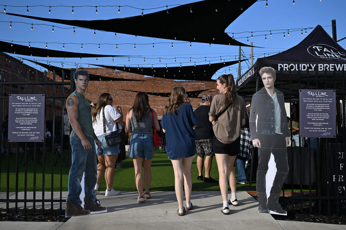Bar crawl attendees walk into Fall Line Brewing Co. for the Twilight Bar Crawl on Friday, Aug. 15, 2025, in Macon, Georgia. The bar crawl featured beers and cocktails at several Macon businesses based on the characters of the hit book and movie series “Twilight.”