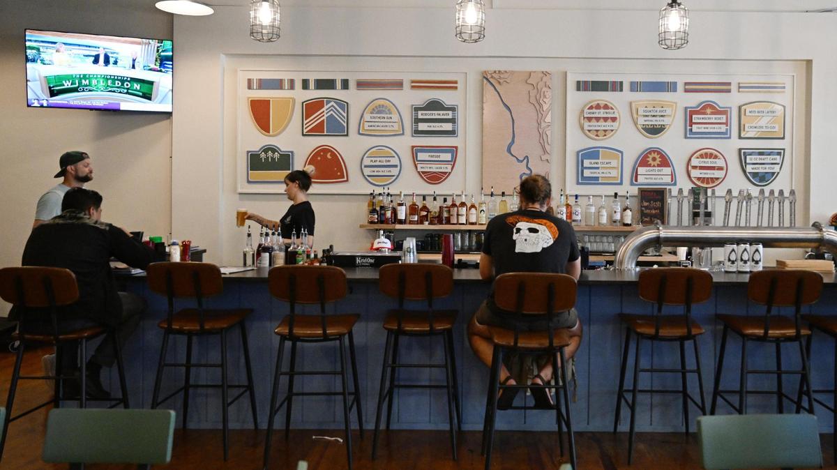 Patrons sit at the new full service bar at Ocmulgee Brewpub on Wednesday, July 9, 2025, in downtown Macon, Georgia. The restaurant’s changes include a full service bar, sit-down only dining and new signage.