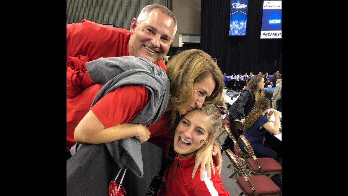GymDog senior Sydney Snead shares an emotional hug with her parents, Michelle and Scott, at the Fort Worth Convention Center during the NCAA national championships on April 19, 2019.