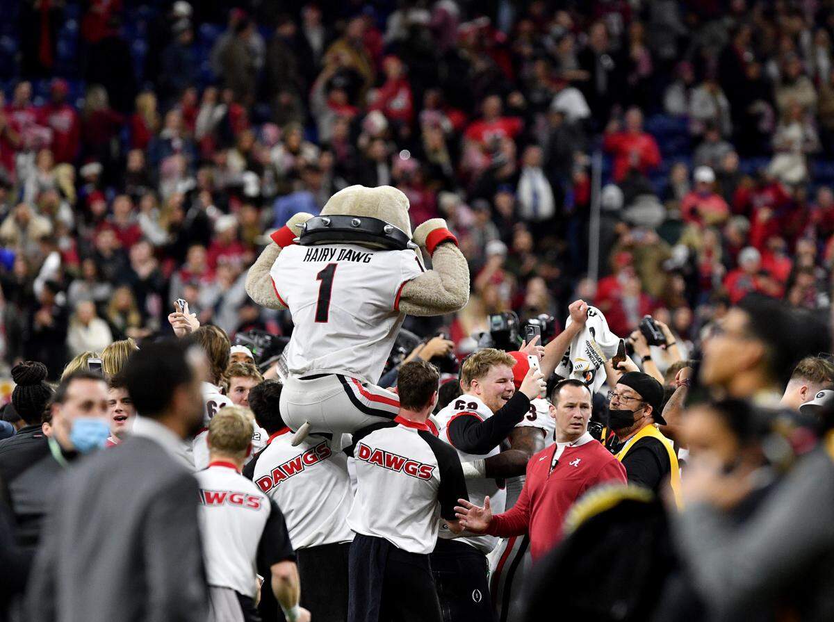 Hairy Dawg gets carried atop the shoulders of cheerleaders while celebrating the Bulldogs’ 33-18 win over Alabama in the College Football Playoff National Championship game Monday night.