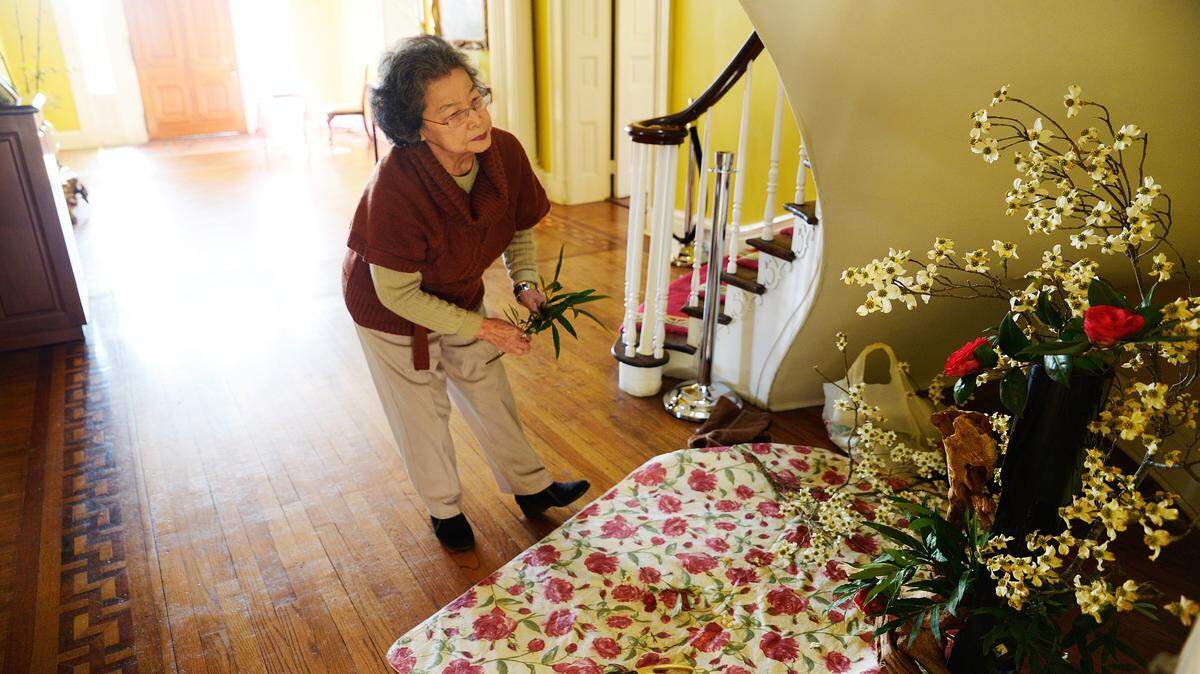 Suko Noll pauses while touching up her flower arrangement during the 2014 Cherry Blossom Festival. Women from the local chapter of Ikebana International will display ornate live floral arrangements Thursday at the Cherry Blossom Festival Fine Art and Wine Reception.