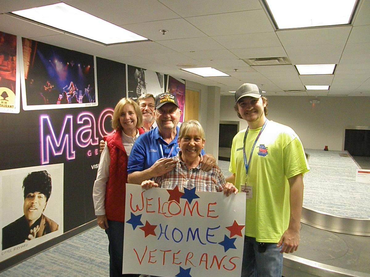 Cheers and signs painted red, white, and blue filled the air of the Middle Georgia Airport in Macon as war veterans were welcomed home from a recent trip to Washington, D.C.
