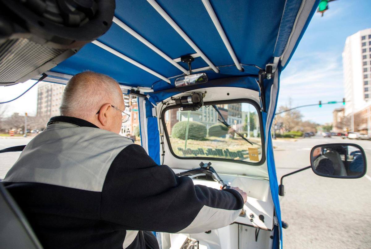 JASON VORHEES/THE TELEGRAPH Macon, GA, 01/25/2019: Gene Watson, co-owner of Macon Needs Rides drives along Mulberry Street in an electric three wheeled vehicle Friday afternoon. The free ride service is scheduled to start in February and relies on advertising for revenue.