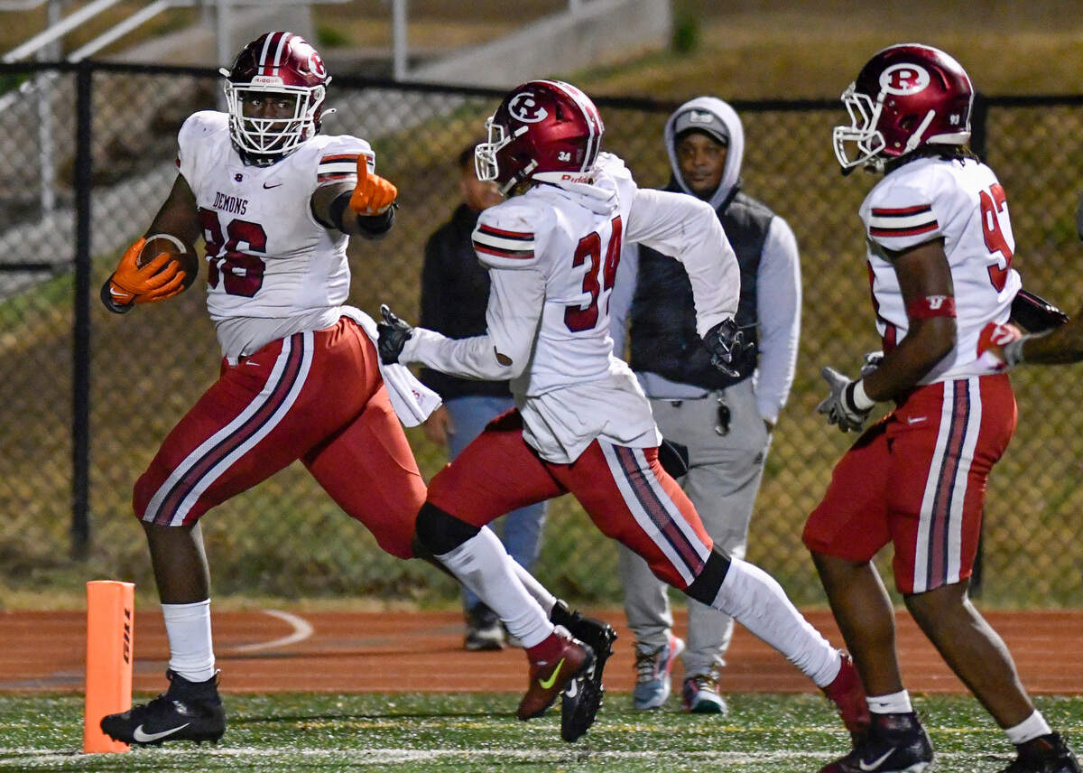 Warner Robins’ Vic Burley (86) runs into the end zone for a touchdown after blocking a punt during the Demons’ 31-28 overtime win at Creekside. Warner Robins plays Ware County Saturday for the 5A state title.