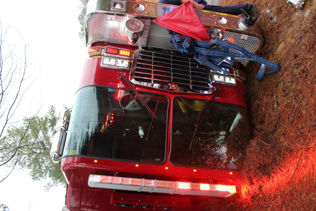 A fire truck flipped on its side after a crash in Monroe County that left one firefighter hurt Thursday morning.