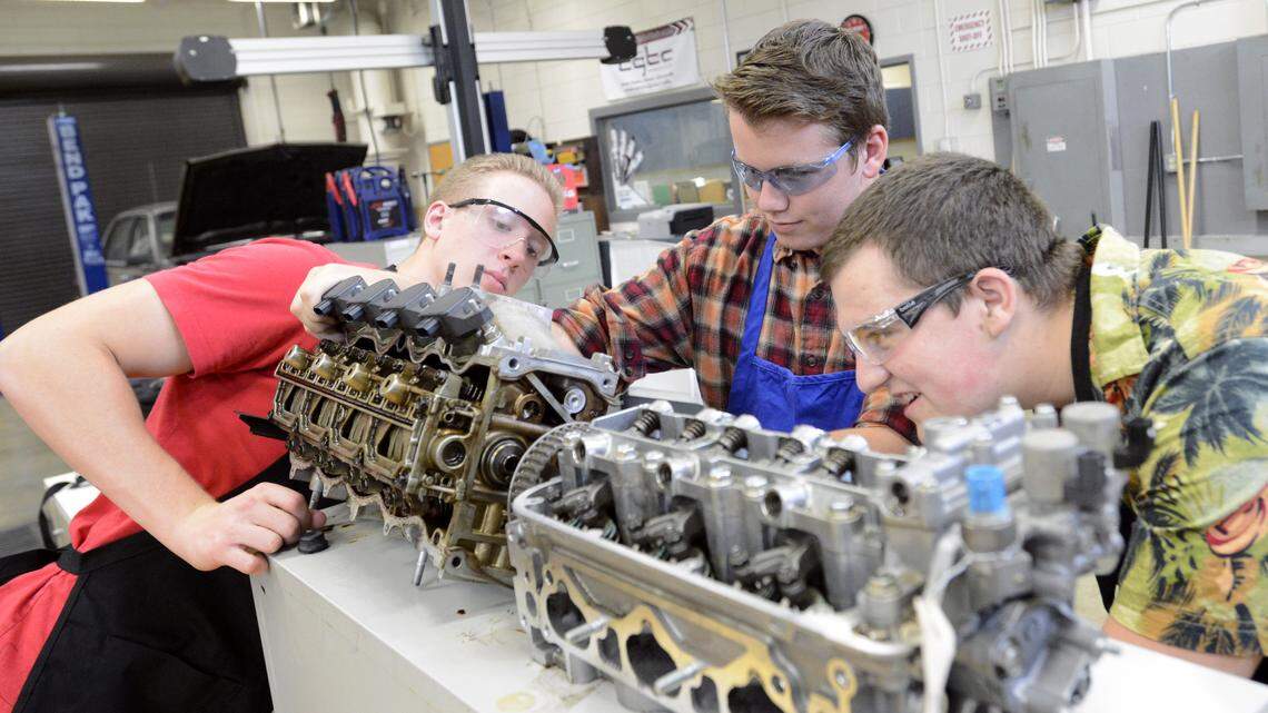Automotive Technology students, from left, Sam Corson, Ryan Stuerman and Taylor Holden look over a cylinder head during class at the Houston County Career Academy in August.