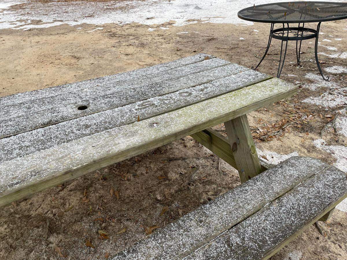 Snow flurries dust a bench at Harvest Church off U.S. 41 in Warner Robins mid-afternoon Tuesday.