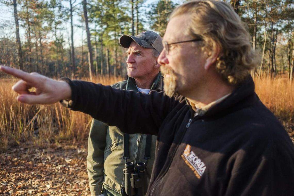 Retired Georgia DNR biologist Jim Ozier (left) and Nathan Klaus converse after the release of relocated endangered woodpecker birds in a new habitat.