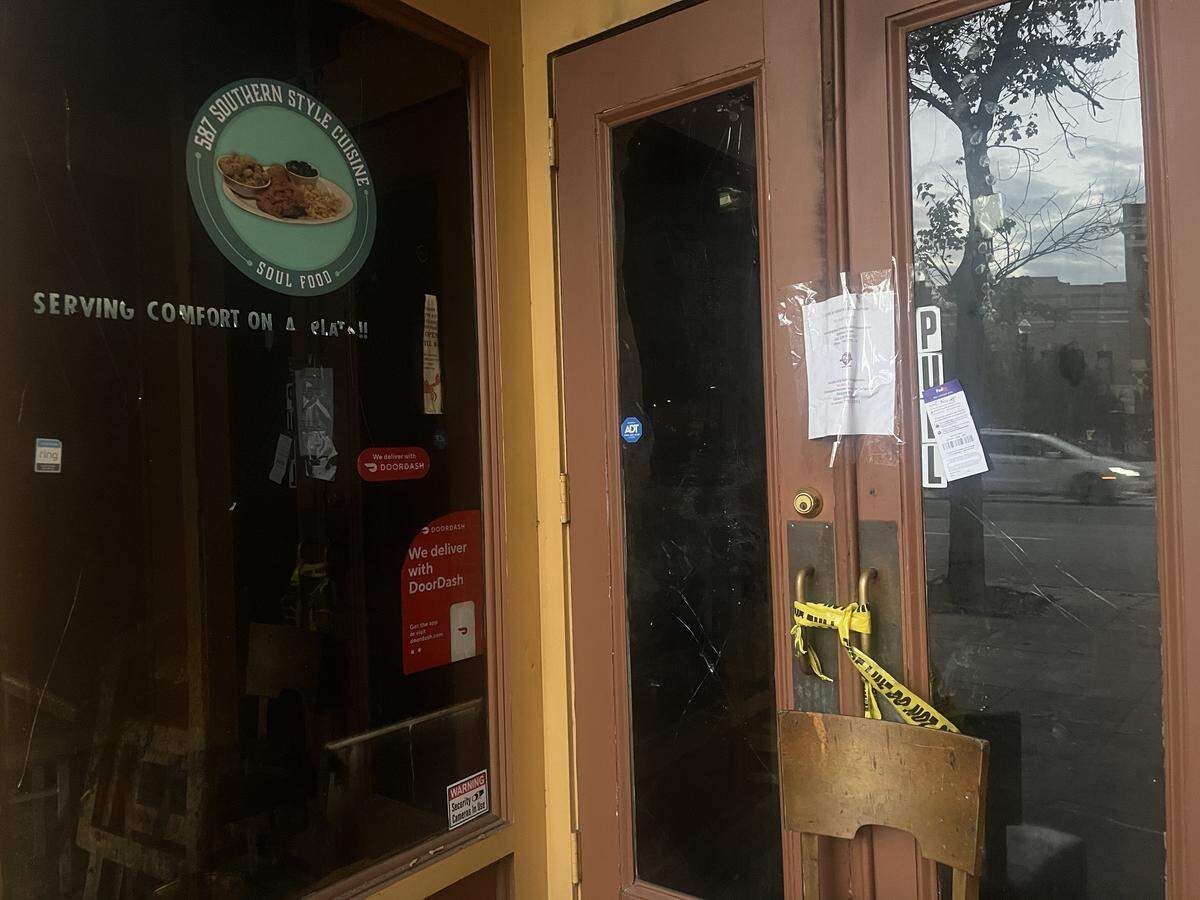 Yellow fire scene tape wraps around front door handles of 578 Southern Style Cuisine, a soul food restaurant in downtown Macon, Ga. on Wednesday, Oct. 15, 2025. A paper above it reads, “SCENE IS UNDER INVESTIGATION. DO NOT DISTURB,” after a fire happened on Sept. 29, at the restaurant.