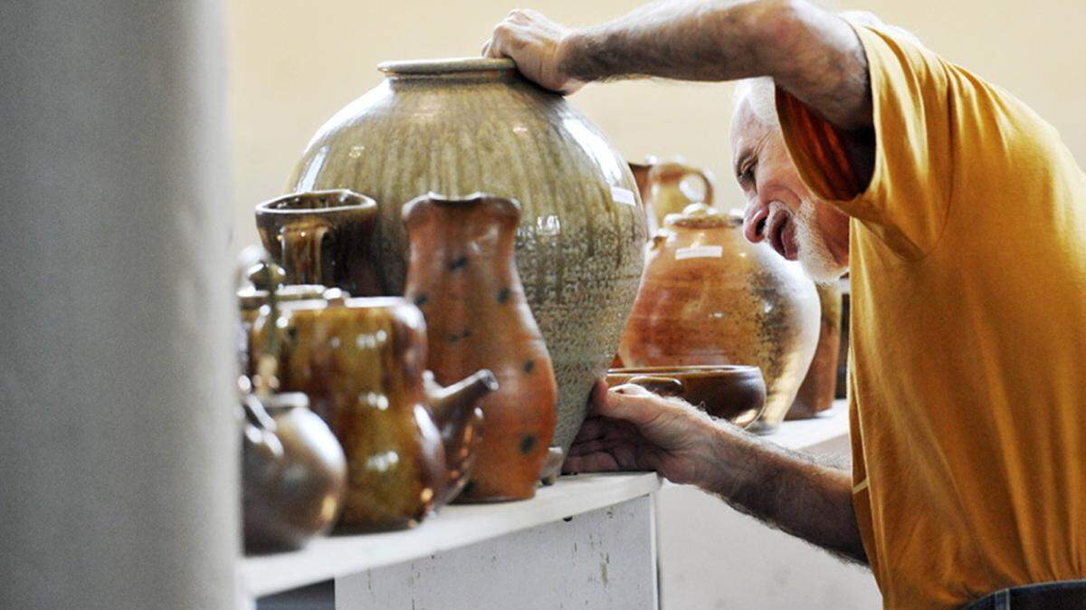 GRANT BLANKENSHIP/THE TELEGRAPHA ceramic artist sets out his wares for Fired Works in 2013.