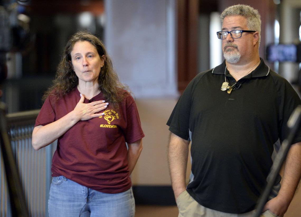 Nicole Poss and her ex-husband, Christian Poss, talk with reporters after Houston County Superior Court Judge Edward D. Lukemire sentenced Dakota White to life in prison without the possibility of parole in the killing of their son, Sam Poss.
