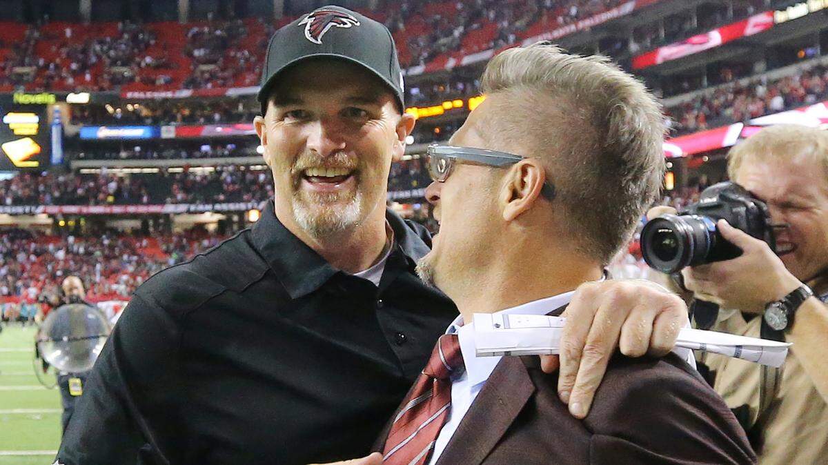 Atlanta Falcons head coach Dan Quinn celebrates winning his first NFL game as a head coach with general manager Thomas Dimitroff after the team beat the Philadelphia Eagles 26-24 on Monday, Sept. 14, 2015, at Georgia Dome in Atlanta.