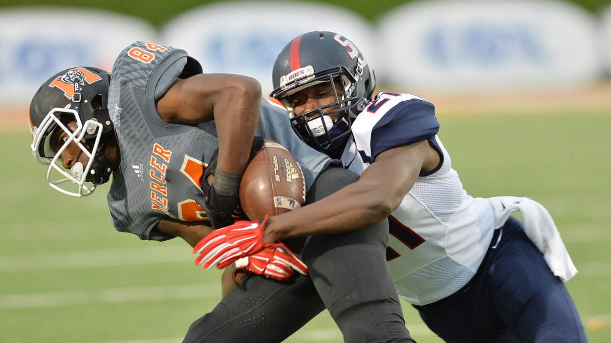 Mercer wide receiver Avery Ward tries to hang onto a John Russ pass after a jarring hit from Samford defensive back James Bradberry during Saturday's game.