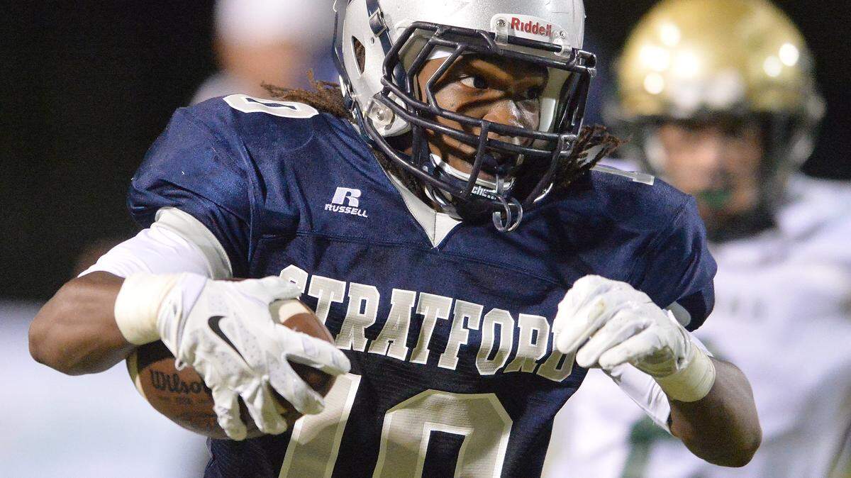 EVAN RODENROTH/For The TELEGRAPH,Warner Robins, Georgia, 09/18/2015: Stratford's OShowen Williams makes his way around the end and heads for a first down against Aquinas High School.