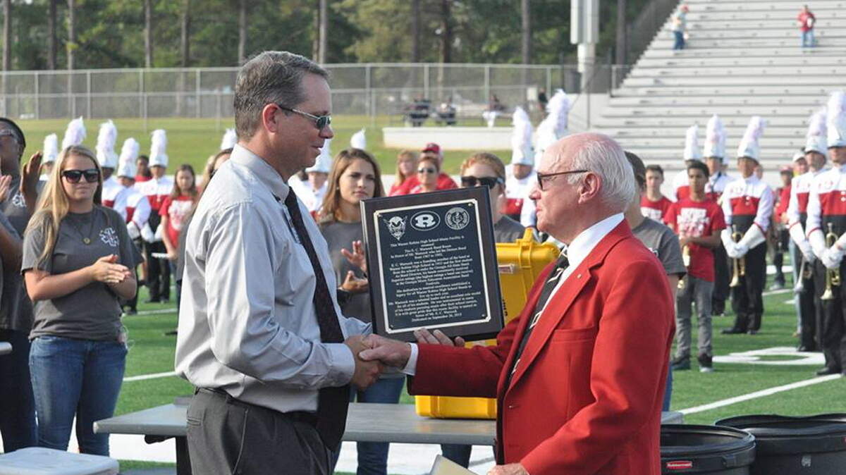Warner Robins High School band director Todd Howell, left, presents E.C. Warnock, the former band director, with a plaque that will hang in the band room named for Warnock.